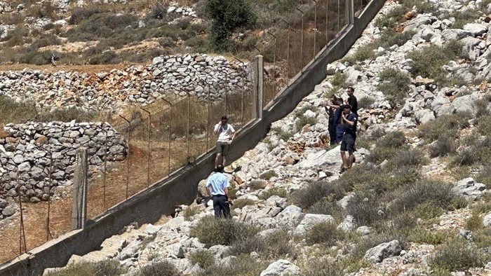 The body of missing British TV presenter Michael Mosley lies on a rocky area on the island of Symi, Sunday, June 9, 2024. The family of missing British TV presenter Dr. Michael Mosley have confirmed his body has been found on a Greek island. Mosley’s wife said Sunday in a statement that her husband had gone for a hike and took the wrong route and collapsed in a place where his body couldn’t easily be seen. (AP Photo/Panormitis Chatzigiannakis)