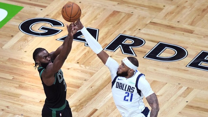Boston Celtics guard Jaylen Brown, left, takes a shot over Dallas Mavericks center Daniel Gafford (21) during the second half of Game 2 of the NBA Finals basketball series, Sunday, June 9, 2024, in Boston. (AP Photo/Michael Dwyer)