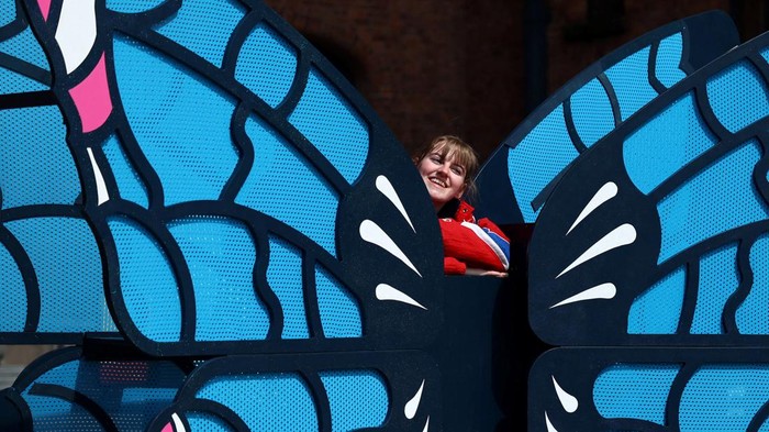 People walk near banners displaying the name of musician Taylor Swift as part of the Taylor Town Trail in anticipation of her arrival, as she will perform three concerts at Anfield Stadium, in Liverpool, Britain June 10, 2024. REUTERS/Molly Darlington