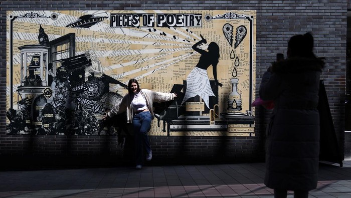 People walk near banners displaying the name of musician Taylor Swift as part of the Taylor Town Trail in anticipation of her arrival, as she will perform three concerts at Anfield Stadium, in Liverpool, Britain June 10, 2024. REUTERS/Molly Darlington