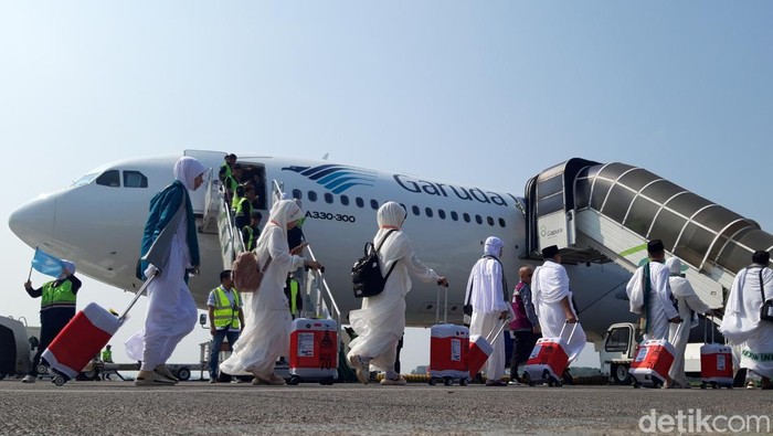 Jemaah calon haji Embarkasi Solo berjalan kaki menuju pesawat di bandara Adi Soemarmo, Boyolali.