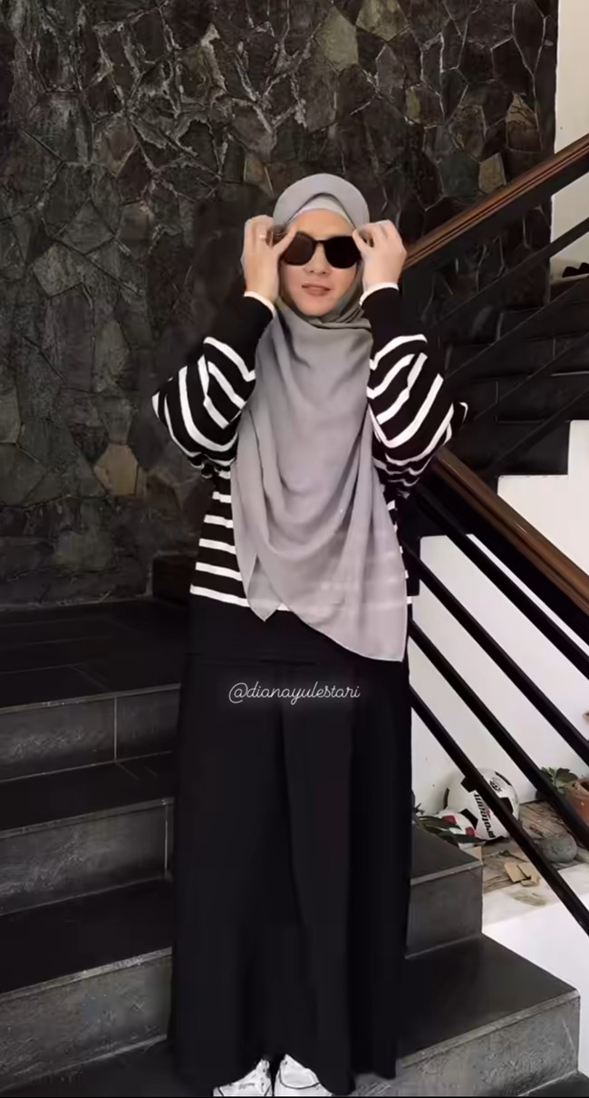 Sedikit berbeda dengan Dian Ayu, Natasha Rizki tetap memilih menggunakan rok panjang dan knitted wear. Ia memakai striped knit warna hitam-putih yang longgar. Foto: Instagram @dianayulestari