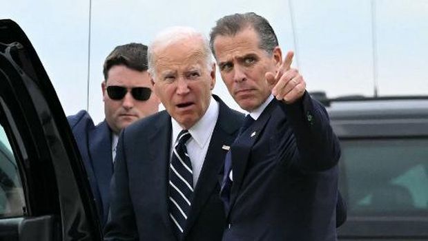US President Joe Biden hugs his son Hunter Biden upon arrival at Delaware Air National Guard Base in New Castle, Delaware, on June 11, 2024, as he travels to Wilmington, Delaware. A jury found Hunter Biden guilty on June 11 on federal gun charges in a historic first criminal prosecution of the child of a sitting US president. The 54-year-old son of President Joe Biden was convicted on all three of the federal charges facing him, CNN and other US media reported. (Photo by ANDREW CABALLERO-REYNOLDS / AFP)