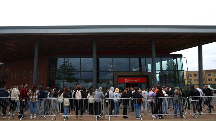 People leave the club shop at Anfield Stadium after an early merchandise release for Taylor Swift fans, in Liverpool, Britain June 12, 2024. REUTERS/Molly Darlington