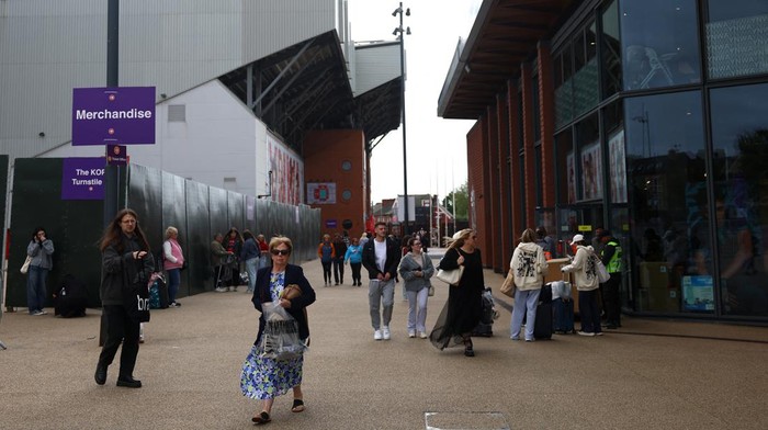 People leave the club shop at Anfield Stadium after an early merchandise release for Taylor Swift fans, in Liverpool, Britain June 12, 2024. REUTERS/Molly Darlington