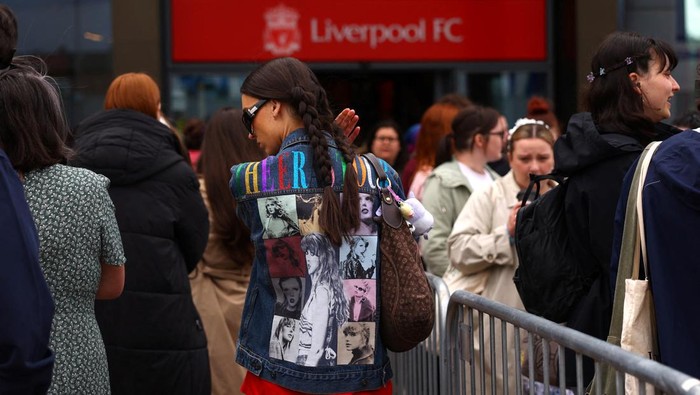 People leave the club shop at Anfield Stadium after an early merchandise release for Taylor Swift fans, in Liverpool, Britain June 12, 2024. REUTERS/Molly Darlington