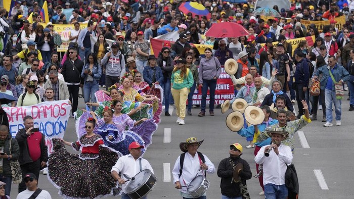 Teachers march to Congress to protest against the Statutory Law on Education, a government initiative for education reforms being considered by lawmakers, on the first day of a teachers' strike in Bogota, Colombia, Wednesday, June 12, 2024. (AP Photo/Fernando Vergara)