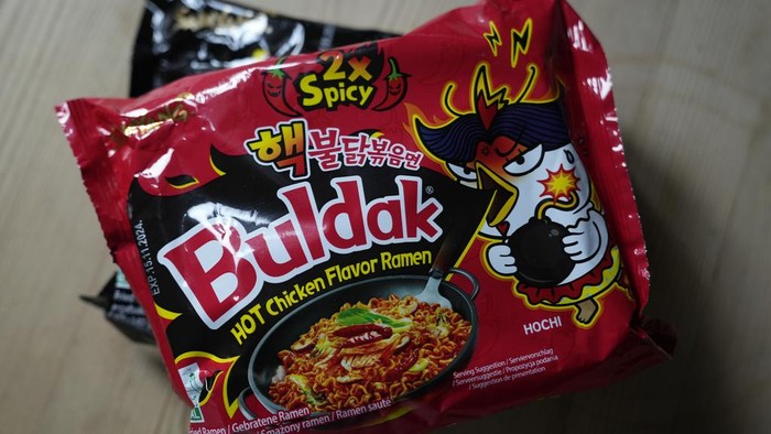 In this photo illustration two packets of Samyang noodles are pictured in London, Wednesday, June 12, 2024. Food authorities in Denmark have recalled three types of spicy instant noodle products imported from South Korea over possible risks for “acute poisoning.”  (AP Photo)