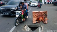 Penutup tersebut rusak dan dihalangi barrier.  