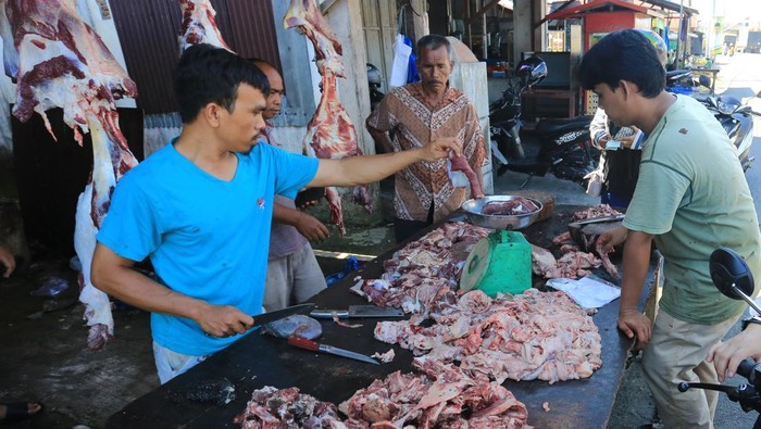 Pedagang musiman mempersiapkan daging kerbau pesanan pembeli pada tradisi meugang kecil (pertama) hari raya Idul Adha di Desa Seneubok, Johan Pahlawan, Aceh Barat, Aceh, Jumat (14/6/2024). Masyarakat Aceh merayakan tradisi Meugang dengan menu utama masakan daging yang dalam setahun digelar saat menyambut bulan suci Ramadhan, jelang Idul Fitri dan jelang Idul Adha dengan harga daging sapi dan kerbau berkisar Rp160 ribu hingga Rp170 ribu per kilogram. ANTARA FOTO/Syifa Yulinnas/foc.