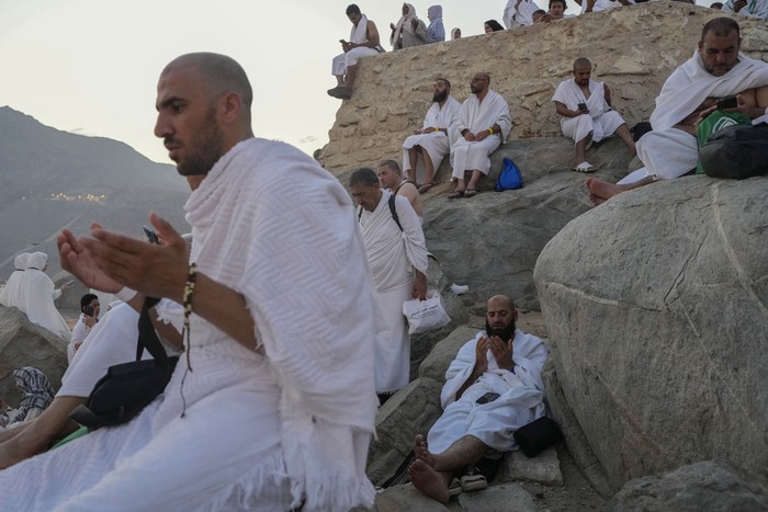 Muslim pilgrims gather at the top of the rocky hill known as the Mountain of Mercy, on the Plain of Arafat, during the annual Hajj pilgrimage, near the holy city of Mecca, Saudi Arabia, Saturday, June 15, 2024. Masses of Muslims gathered at the sacred hill of Mount Arafat in Saudi Arabia for worship and reflection on the second day of the Hajj pilgrimage. The ritual at Mount Arafat, known as the hill of mercy, is considered the peak of the Hajj. Its often the most memorable event for pilgrims, who stand shoulder to shoulder, asking God for mercy, blessings, prosperity and good health. Hajj is one of the largest religious gatherings on earth. (AP Photo/Rafiq Maqbool)