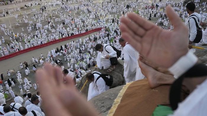 Muslim pilgrims gather at the top of the rocky hill known as the Mountain of Mercy, on the Plain of Arafat, during the annual Hajj pilgrimage, near the holy city of Mecca, Saudi Arabia, Saturday, June 15, 2024. Masses of Muslims gathered at the sacred hill of Mount Arafat in Saudi Arabia for worship and reflection on the second day of the Hajj pilgrimage. The ritual at Mount Arafat, known as the hill of mercy, is considered the peak of the Hajj. Its often the most memorable event for pilgrims, who stand shoulder to shoulder, asking God for mercy, blessings, prosperity and good health. Hajj is one of the largest religious gatherings on earth. (AP Photo/Rafiq Maqbool)