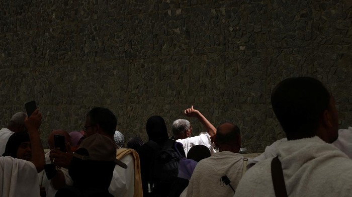 A woman reacts as Muslim pilgrims cast stones at a pillar symbolising Satan, during the annual haj pilgrimage in Mina, Saudi Arabia, June 16, 2024. REUTERS/Saleh Salem
