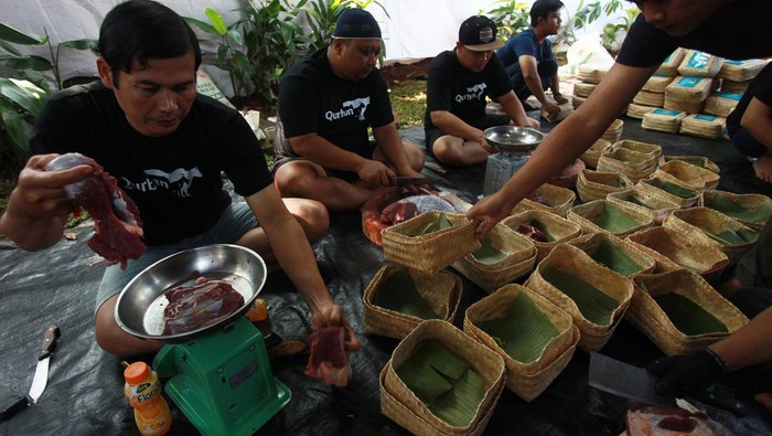 Petugas mengemas daging hewan kurban ke dalam besek bambu saat pemotongan hewan kurban di Jakarta, Senin (17/6/2024). Pengemasan daging kurban dengan menggunakan besek bambu yang ramah lingkungan tersebut sebagai langkah dalam mengurangi penggunaan kantong plastik saat Hari Raya Idul Adha sesuai dengan surat edaran yang dikeluarkan oleh pemerintah. ANTARA FOTO/Reno Esnir/wpa/nym.
