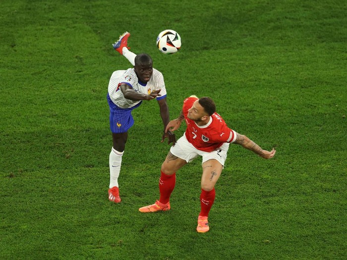 DUSSELDORF, GERMANY - JUNE 17: N'Golo Kante of France looks on as Marko Arnautovic of Austria wins a header during the UEFA EURO 2024 group stage match between Austria and France at Düsseldorf Arena on June 17, 2024 in Dusseldorf, Germany. (Photo by Lars Baron/Getty Images)