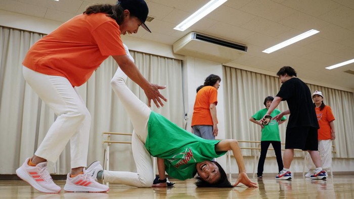 Members of Ara Style Senior, Japan's only breakdancing club made up of elderly citizens, and their instructor Yusuke Arai, 38, pose for a picture after their final rehearsal ahead of their performance at a local festival in Tokyo, Japan, May 24, 2024. Ara Style senior now compromises about 15 members, and although the moves are far from what will be performed at the Olympics, the team's goal is to have fun and stay fit. 