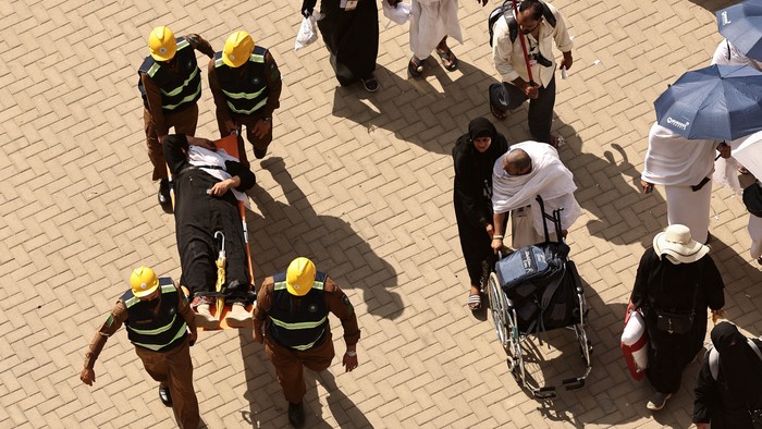 Rescuers carry away a man effected by the scorching heat as Muslim pilgrims perform the symbolic stoning of the devil ritual as part of the hajj pilgrimage in Mina, near Saudi Arabias holy city of Mecca, on June 16, 2024. Pilgrims perform the last major ritual of the hajj, the 