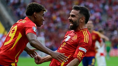 Spains defender #02 Dani Carvajal celebrates with Spains forward #19 Lamine Yamal after scoring his teams third goal during the UEFA Euro 2024 Group B football match between Spain and Croatia at the Olympiastadion in Berlin on June 15, 2024. (Photo by JOHN MACDOUGALL / AFP)