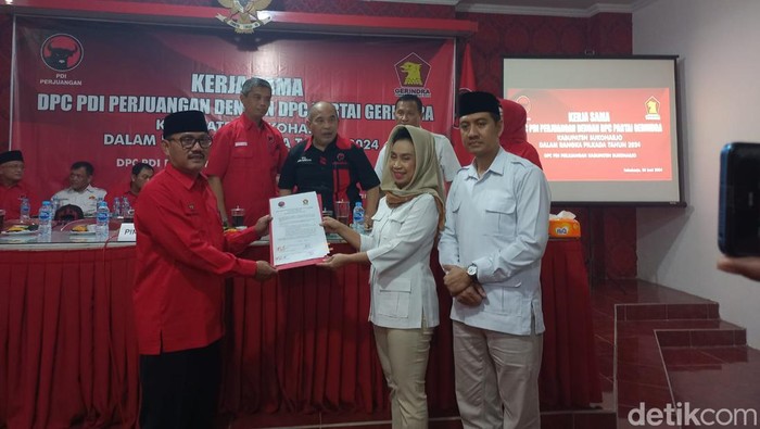 Pimpinan DPC PDIP Sukoharjo dan DPC Gerindra Sukoharjo menunjukkan surat kerja sama di kantor DPC PDIP Sukoharjo, Kamis (20/6/2024).