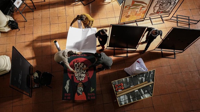Workers prepare art from around the world for an exhibition called, 