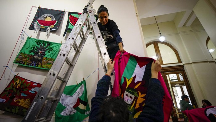 Workers prepare art from around the world for an exhibition called, 