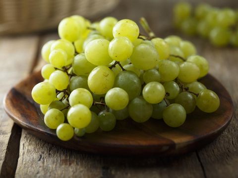Ripe white grape on wooden desk