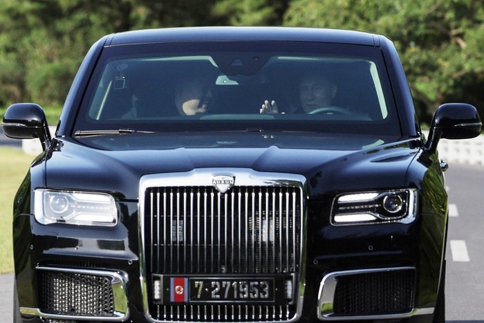 In this pool photograph distributed by the Russian state agency Sputnik, Russian President Vladimir Putin (R) and North Koreas leader Kim Jong Un (L) drive an Aurus car in Pyongyang, on June 19, 2024. Russian President Vladimir Putin signed a mutual defence agreement on June 19 with North Koreas Kim Jong Un, who offered his 
