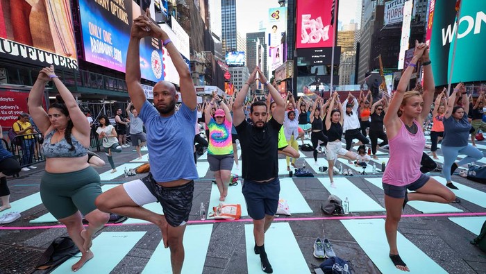 People practice yoga during the 22nd annual 