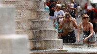Orang-orang bersantai di Fontana dei Leoni (Air Mancur Empat Singa) di Piazza del Popolo di tengah gelombang panas di Roma, Italia. REUTERS/Yara Nardi