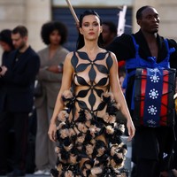 Penampilan Katy di runway ditemani dengan riasan dramatis, blush on merah muda yang mencolok, dan lipstik yang bold, menambah kesan berani pada keseluruhan tampilannya. Foto: Getty Images for Vogue/Marc Piasecki