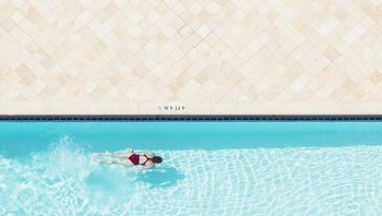 Karya David Behar, raih Gold di kategori Minimalism. Bersandar di atas balkon apartemen bibi saya di Miami Beach, saya melihat seorang wanita berbaju merah pergi berenang, jadi saya kembali untuk mengambil kamera saya. Foto: 1839 Awards