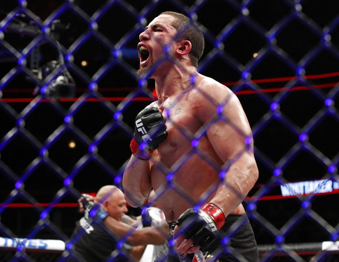 Robert Whittaker reacts after his middleweight mixed martial arts title bout against Yoel Romero at UFC 225 early Sunday, June 10, 2018, in Chicago. (AP Photo/Jim Young)