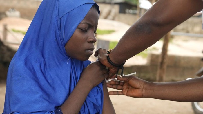 A health worker administers a cervical cancer vaccine HPV Gardasil to a girl on the street in Ibadan, Nigeria, on May 27, 2024. African countries have some of the world's highest rates of cervical cancer. Growing efforts to vaccinate more young girls for the human papillomavirus are challenged by the kind of vaccine hesitancy seen for some other diseases. Misinformation can include mistaken rumors that girls won't be able to have children in the future. Some religious communities must be told that the vaccine is 
