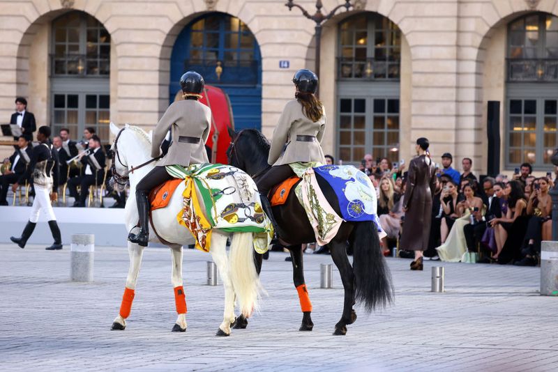 PARIS, FRANCE - JUNE 23: Kendall Jenner and Gigi Hadid ride horses on the runway during Vogue World: Paris at Place Vendome on June 23, 2024 in Paris, France. (Photo by Kristy Sparow/Getty Images for Vogue)