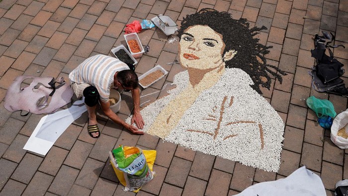 Kosovo artist Alkent Pozhegu works on a mosaic made of grains showing a portrait of Michael Jackson on the 15th anniversary of his death in Gjakova, Kosovo June 25, 2024. REUTERS/Valdrin Xhemaj