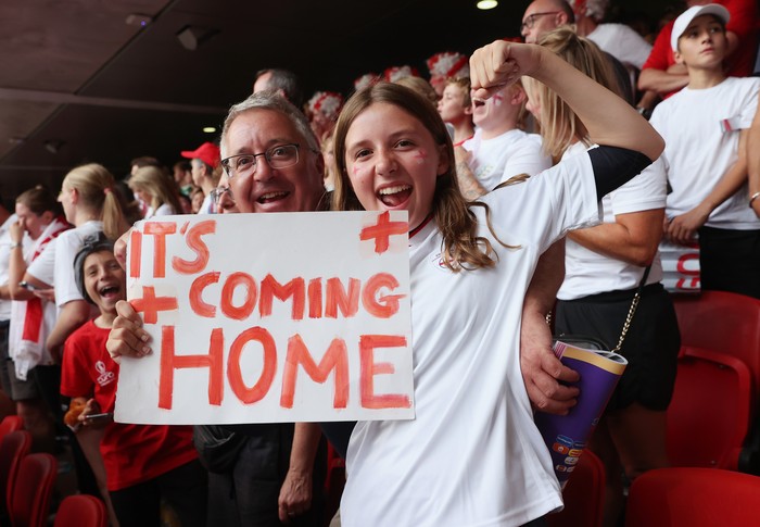 LONDON, ENGLAND - JULY 31: England fans celebrate with a sign that reads Its Coming Home following victory during the UEFA Womens Euro 2022 final match between England and Germany at Wembley Stadium on July 31, 2022 in London, England. (Photo by Julian Finney - The FA/The FA via Getty Images)