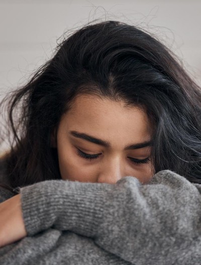Woman, stress and depression in lonely mental health problems, issues or anxiety at home. Sad female face suffering from loneliness, withdrawal or abuse with depressed emotion alone in the bedroom