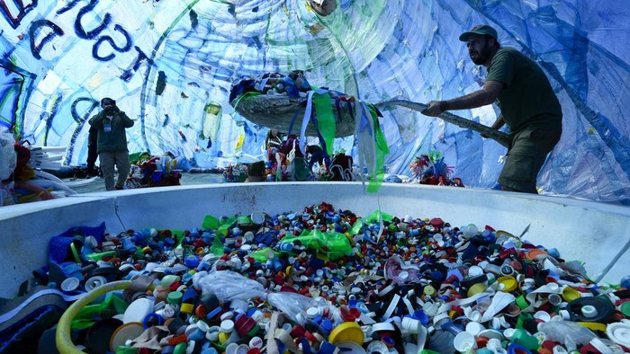 People look at environmental activist Mundano's installation titled 