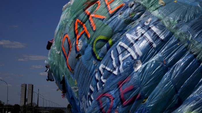 People look at environmental activist Mundano's installation titled 