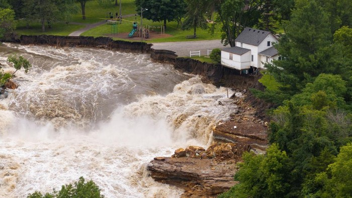 A drone view shows debris accumulating on the Rapidan Dam after torrential rains caused the Blue Earth River to swell, southwest of Mankato, Minnesota, U.S. June 25, 2024. REUTERS/Ben Brewer