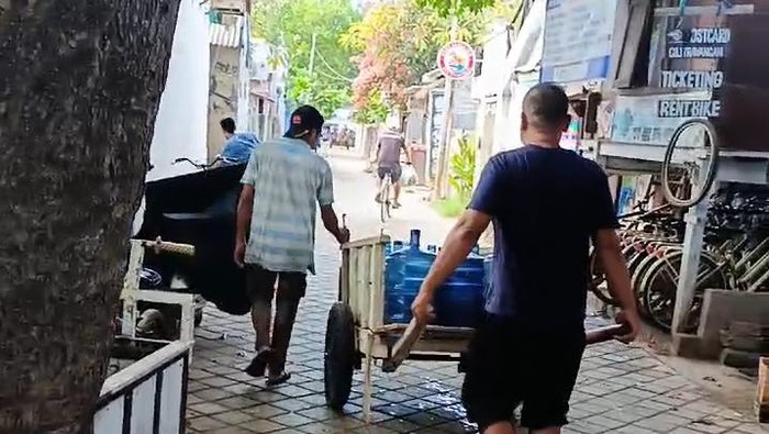 Penyidik Ditreskrimsus Polda NTB memeriksa air galon milik PT Carpedien di Gili Trawangan, Desa Gili Indah, Kecamatan Pemenang, Lombok Utara, NTB. (Dok. Khairil Anwar)