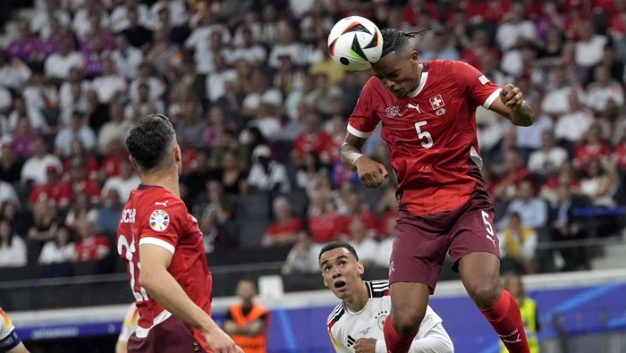 Switzerlands Manuel Akanji heads the ball during a Group A match between Switzerland and Germany at the Euro 2024 soccer tournament in Frankfurt, Germany, Sunday, June 23, 2024. (AP Photo/Martin Meissner)