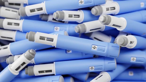 A large group of injectors / dosing pens  for subcutaneous injection of antidiabetic medication or anti-obesity medication on a heap. Selective focus.