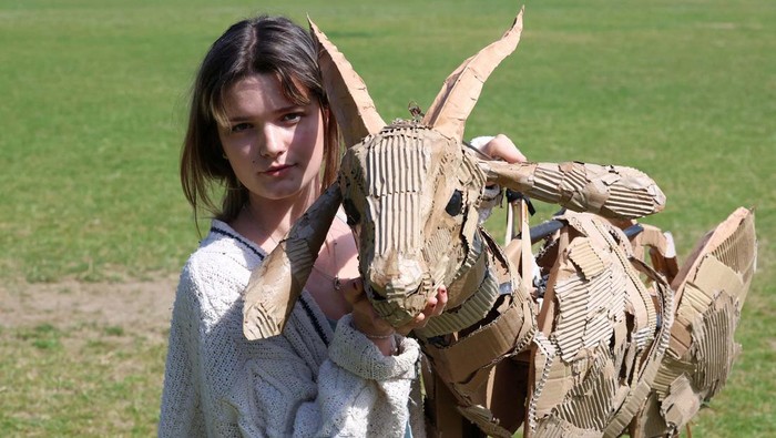 A puppeteer displays a life-size puppet of a wild animal at the launch of 