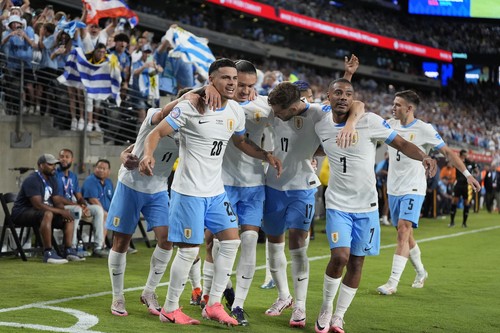 Uruguays Maximiliano Araujo, left, celebrates with teammates after scoring his sides third goal against Bolivia during a Copa America Group C soccer match in East Rutherford, N.J., Thursday, June 27, 2024. (AP Photo/Julia Nikhinson)