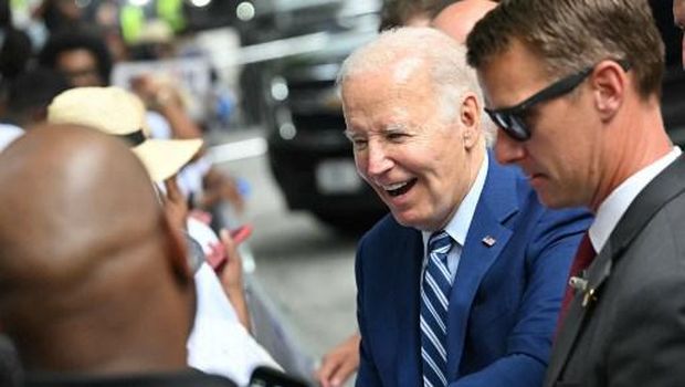 US President Joe Biden greets supporters outside his hotel ahead of the first presidential debate of the 2024 elections at CNN's studios in Atlanta, Georgia, on June 27, 2024. (Photo by Mandel NGAN / AFP)