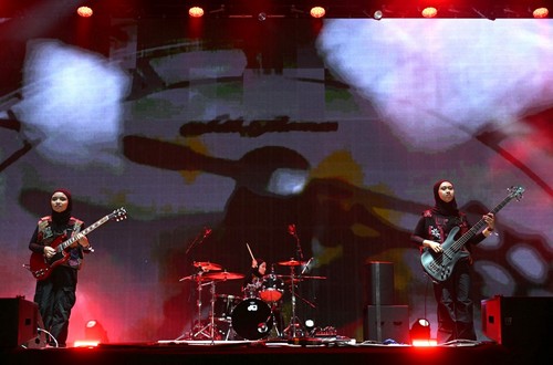 Firda Marsya Kurnia (L) and Widi Rahmawati of Indonesian rock band Voice of Baceprot, perform on the Woodsies stage on the third day of the Glastonbury festival at Worthy Farm in the village of Pilton in Somerset, southwest England, on June 28, 2024. The festival takes place from June 26 to June 30. (Photo by Oli SCARFF / AFP)