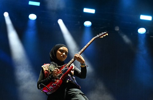 Firda Marsya Kurnia (L) and Widi Rahmawati of Indonesian rock band Voice of Baceprot, perform on the Woodsies stage on the third day of the Glastonbury festival at Worthy Farm in the village of Pilton in Somerset, southwest England, on June 28, 2024. The festival takes place from June 26 to June 30. (Photo by Oli SCARFF / AFP)
