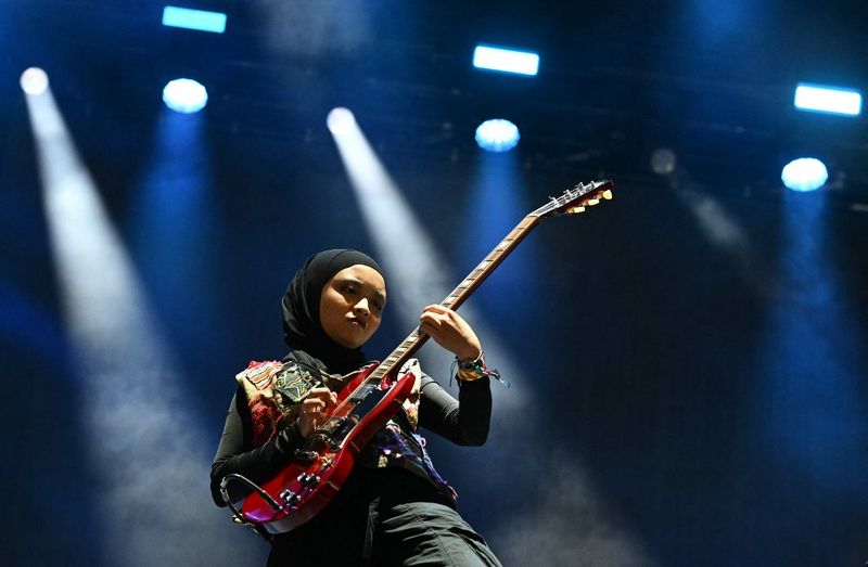 Firda Marsya Kurnia (L) and Widi Rahmawati of Indonesian rock band Voice of Baceprot, perform on the Woodsies stage on the third day of the Glastonbury festival at Worthy Farm in the village of Pilton in Somerset, southwest England, on June 28, 2024. The festival takes place from June 26 to June 30. (Photo by Oli SCARFF / AFP)