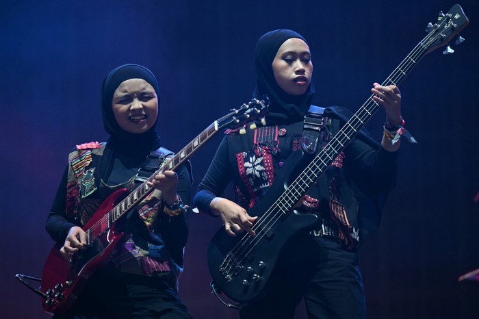 BRITAIN-MUSIC-FESTIVAL Firda Marsya Kurnia (L) and Widi Rahmawati of Indonesian rock band Voice of Baceprot, perform on the Woodsies stage on the third day of the Glastonbury festival at Worthy Farm in the village of Pilton in Somerset, southwest England, on June 28, 2024. The festival takes place from June 26 to June 30. (Photo by Oli SCARFF / AFP)